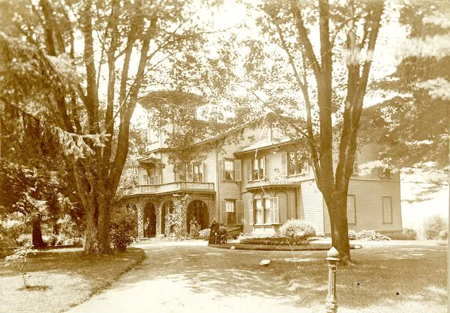 A view of Acorn Hall from the driveway, c1900. Augustus Crane is seated with his wife Mary Crane standing beside him. (Courtesy of Morris County Historical Society)
