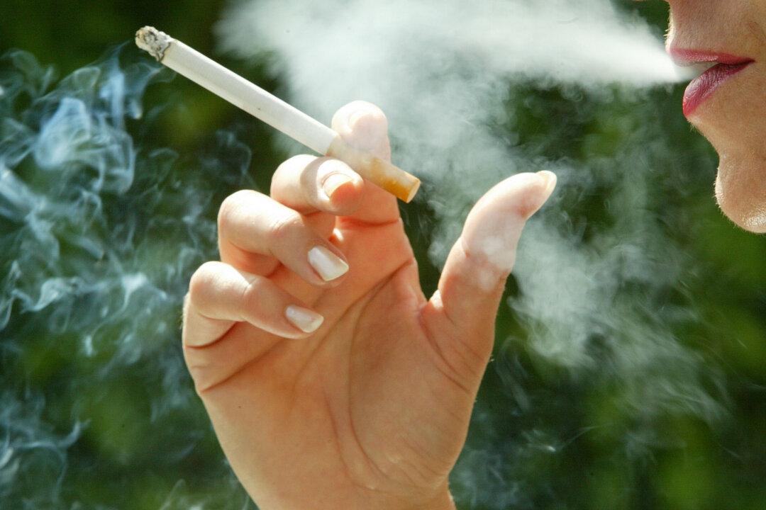 A woman smokes a cigarette June 30, 2003 in Paris, France. (Pascal Le Segretain/Getty Images)