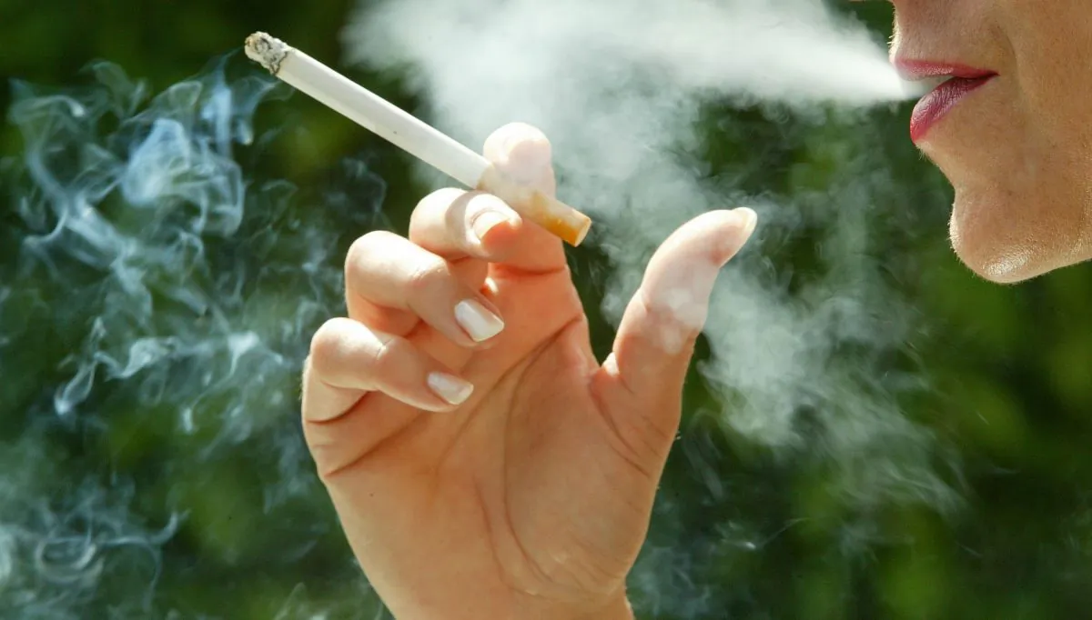 A woman smokes a cigarette June 30, 2003 in Paris, France. (Pascal Le Segretain/Getty Images)