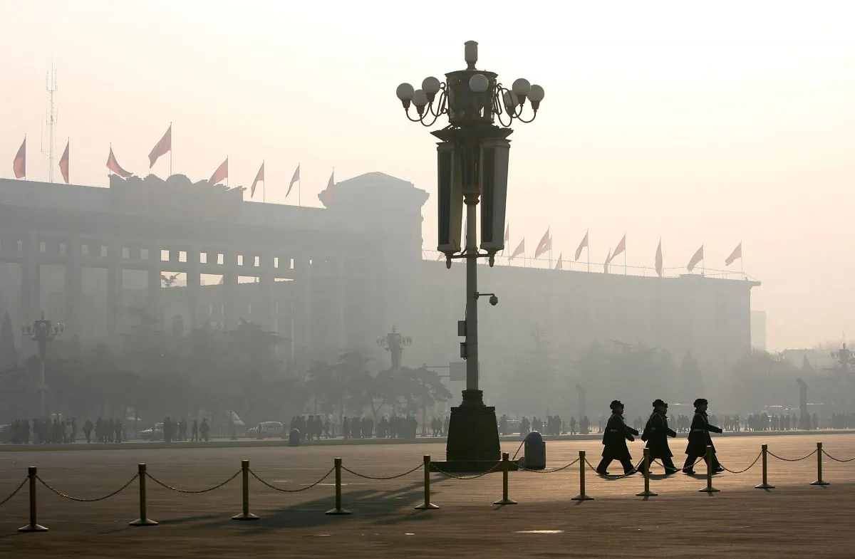 Chinese police officers patrol Tiananmen Square while security cameras monitor the area in Beijing in this file photo. (Cancan Chu/Getty Images)