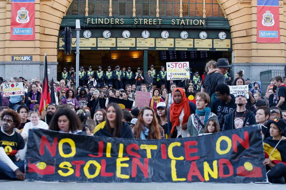Protesters take part in a traditional smoking ceremony at the intersection of Swanston and Flinders street on April 10, 2015 in Melbourne, Australia. (Darrian Traynor/Getty Images)