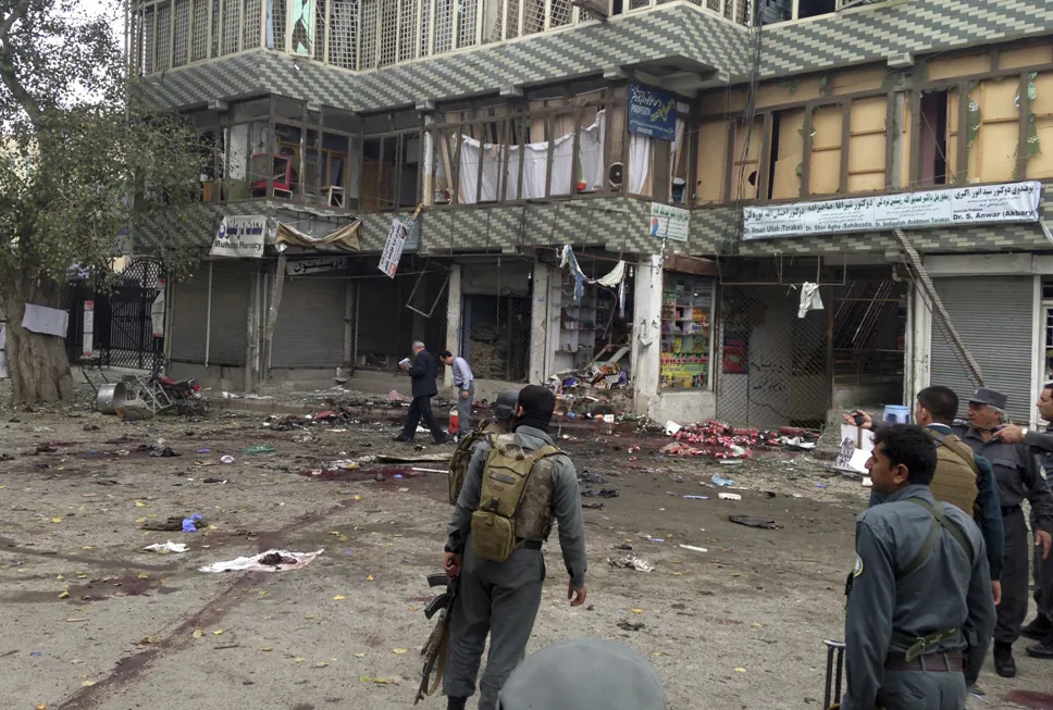 Afghan security forces inspect the site of a suicide attack near a bank branch in Jalalabad, east of Kabul, Afghanistan, Saturday, April 18, 2015. (AP Photo)