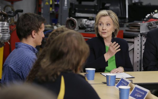 In this April 14, 2015, photo, Democratic presidential candidate Hillary Rodham Clinton, right, participates in a roundtable with educators and students at the Kirkwood Community College's Jones County Regional Center in Monticello, Iowa. This time around, Clinton wants to be on liberals’ good side. In 2008, the then-first time presidential candidate opposed gay marriage, equivocated on granting driver’s licenses to illegal immigrants, and took a beating from rival Barack Obama over her stance on campaign finance. During the first week of her second presidential campaign, Clinton ticked through those missteps one by one, carefully retooling her positions to line up with the views of progressive Democrats. (AP Photo/Charlie Neibergall)