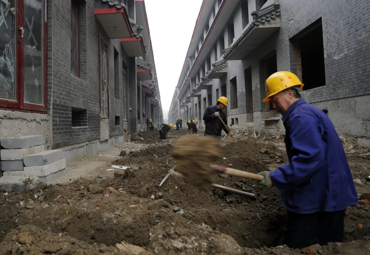 Workers go about their chores at a construction site for new shops in Beijing on November 28, 2011. (Goh Chai Hin/AFP/Getty Images)
