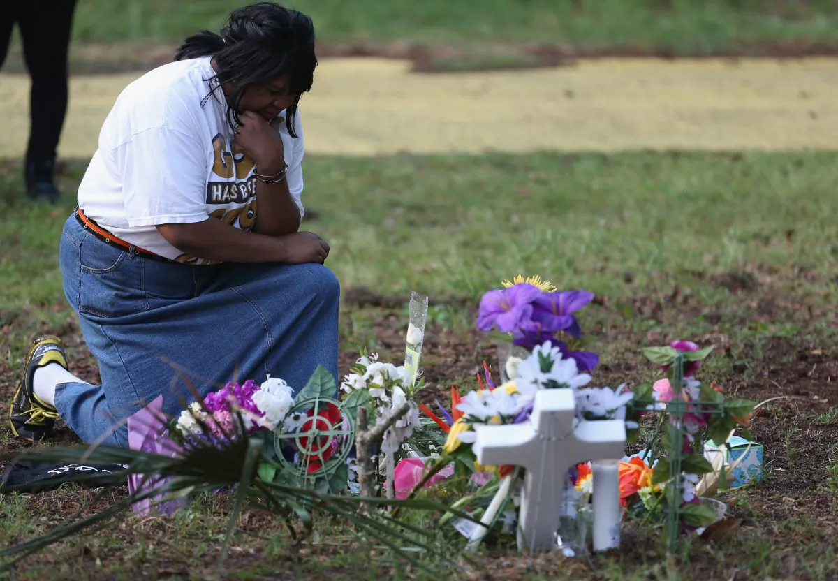 Marie Fogle Hamilton prays as she visits a memorial set up on the site where Walter Scott was killed on April 11 in North Charleston, S.C. Chad Posick argues the practice of empathy could help prevent incidents such as the Walter Scott shooting. (Joe Raedle/Getty Images)
