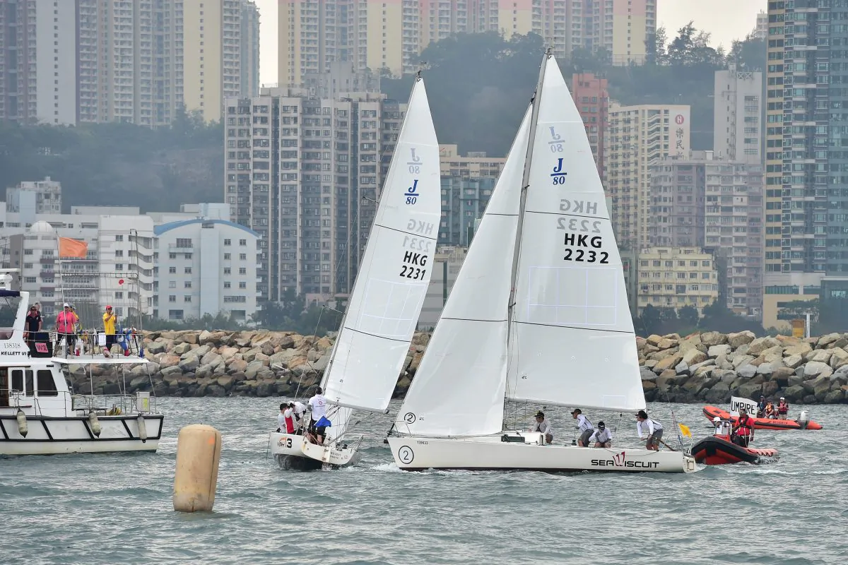 Regatta winner Maximilian Soh (Sail 2232) of Singapore, 'fights' with runner up Jeremy Koo (2231) of Malaysia before the start of their round robin match in the Hong Kong International Match Racing Regatta, organized by the Royal Hong Kong Yacht Club and held in Victoria Harbour on Saturday and Sunday April 18-19, 2015. (Bill Cox/Epoch Times)