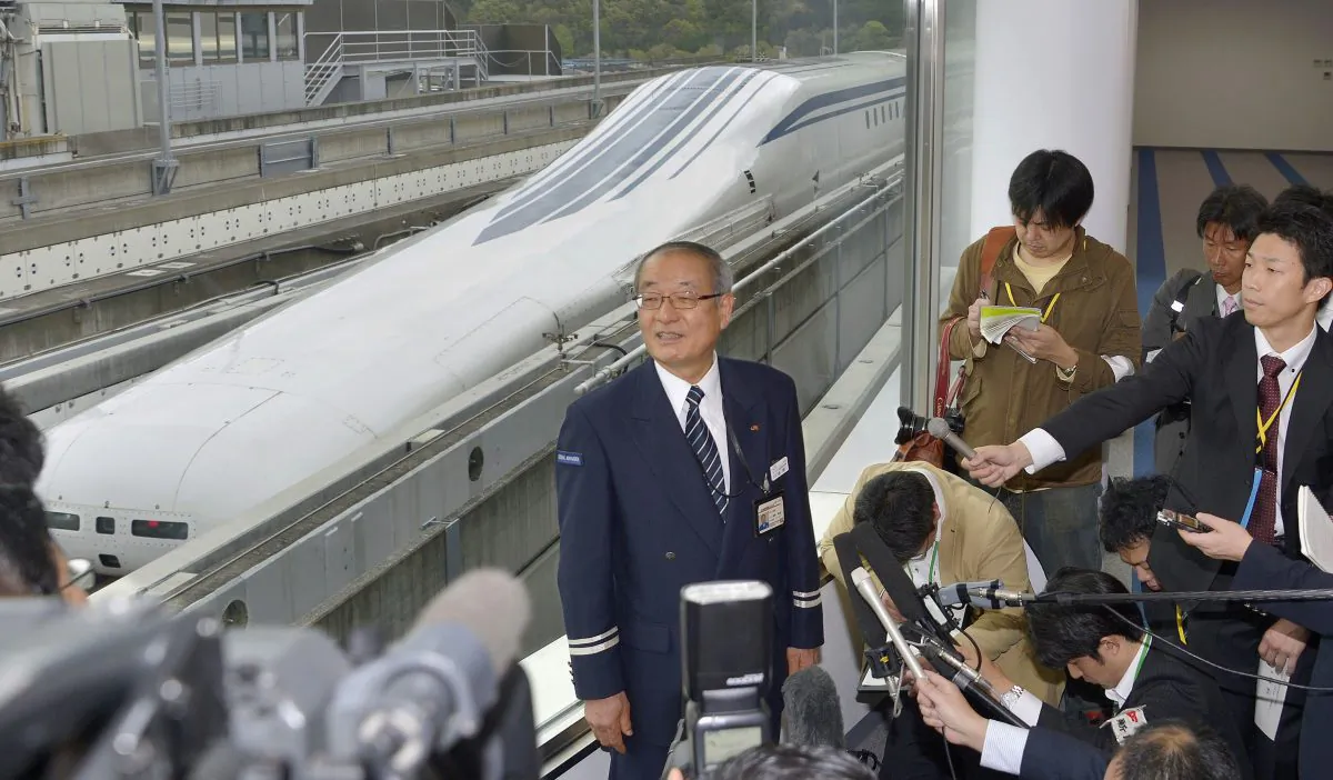 Yasukazu Endo, general manager of JR Central's Yamanashi Maglev Test Line Test Center, answers a reporter's question after a Japanese maglev train that is the fastest passenger train in the world broke its own speed record in Tsuru, about 80 kilometers (50 miles) west of Tokyo Tuesday, April 21, 2015. Operator JR Central said the train reached 603 kilometers per hour (375 miles per hour) in the test run on Tuesday, surpassing its previous record of 361 mph (581 kph) set in 2003. (Katsuya Miyagawa/Kyodo News via AP)