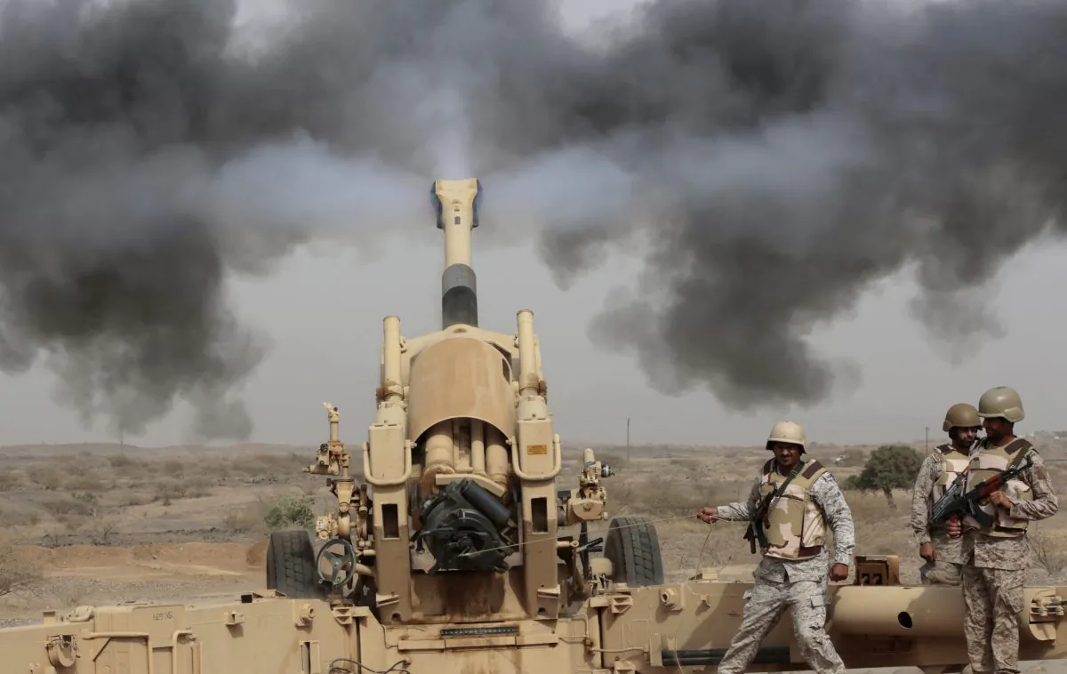 Saudi soldiers fire artillery toward three armed vehicles approaching the Saudi border with Yemen in Jazan, Saudi Arabia, on April 20, 2015. (Hasan Jamali/AP)