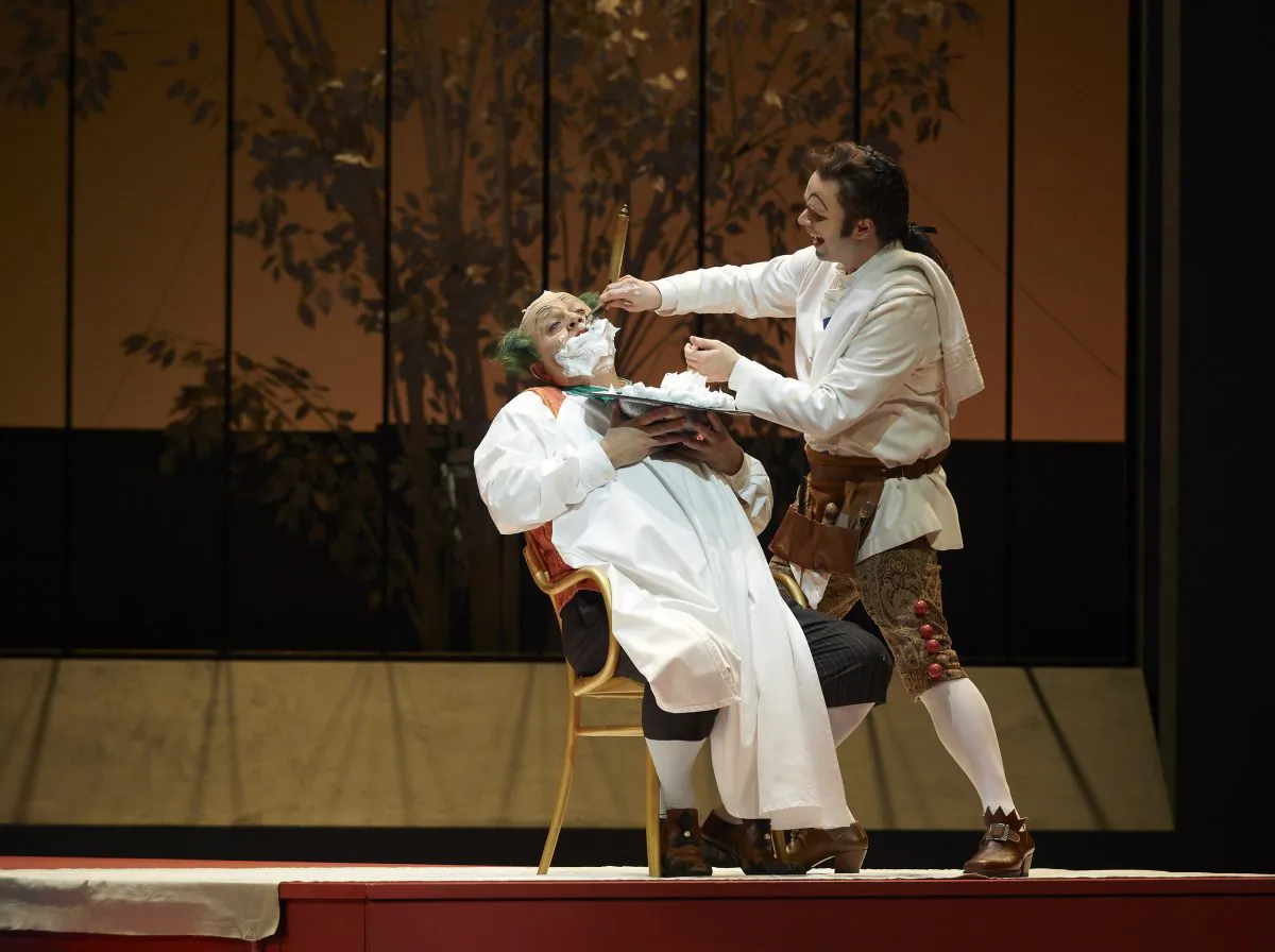 Renato Girolami as Doctor Bartolo and Joshua Hopkins as Figaro in the Canadian Opera Company production of “The Barber of Seville.” (Michael Cooper)
