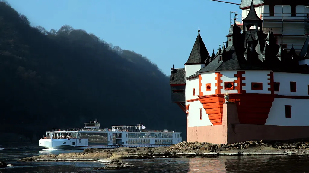 A Viking longboat crusises past a castle on the River Rhine. The Rhine is lined with castles and vineyards. (Viking River Cruises)