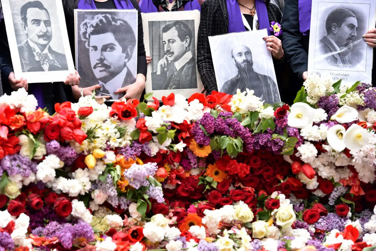 People holding photographs attend a flower laying ceremony at the Tsitsernakaberd Memorial, on April 24, 2015 in Yerevan, Armenia, as part of the Armenian genocide centenary commemoration. Armenians on April 24 marked the centenary of the massacre of up to 1.5 million of their kin  (KIRILL KUDRYAVTSEV/AFP/Getty Images)