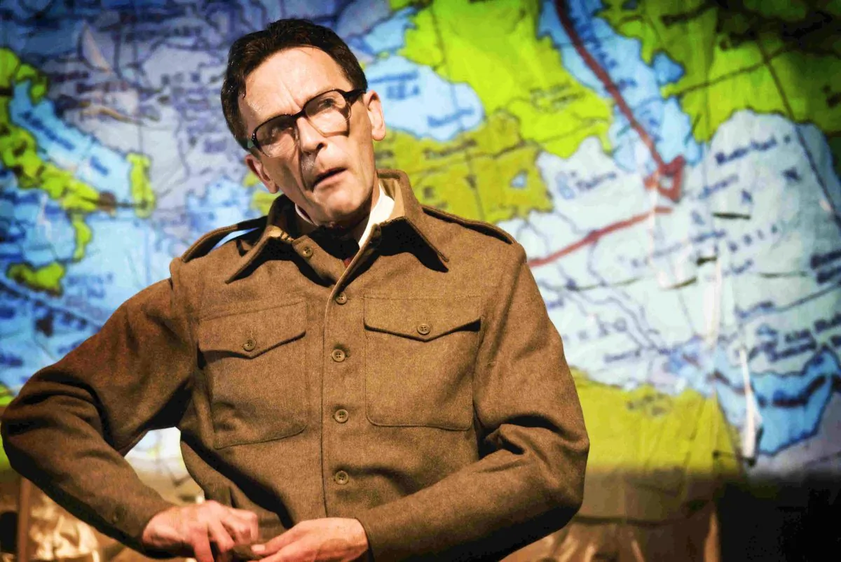 Matthew Zajac in the one-man play, "The Tailor of Inverness," uses projected maps to trace possible routes his father took in WWII. (Tim Morozzo)