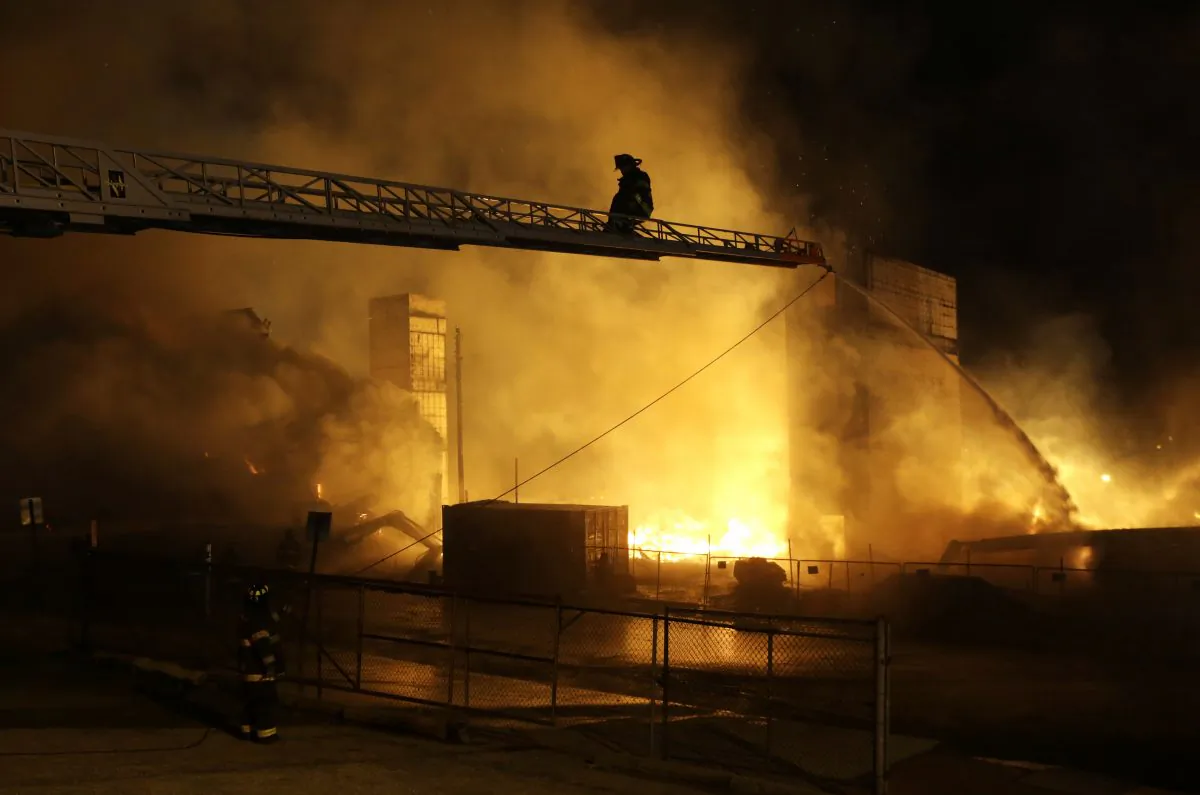Firefighters battle a blaze, Monday, April 27, 2015, after rioters plunged part of Baltimore into chaos, torching a pharmacy, setting police cars ablaze and throwing bricks at officers. (AP Photo/Patrick Semansky)