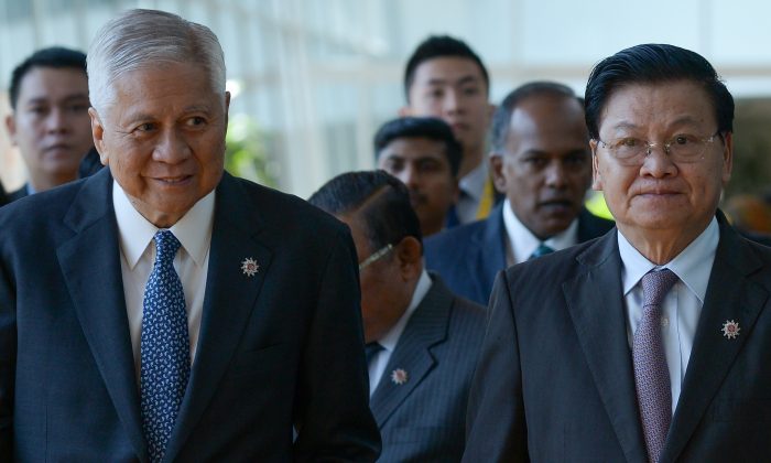Philippines's Foreign Affairs Minister Albert del Rosario (L) and Laos' Foreign Minister Thongloun Sisoulith arrive for the ASEAN Foreign Ministers Meeting (AMM) in Kuala Lumpur on April 26. ASEAN members are expected to call for a code of conduct on the South China Sea. (MOHD RASFAN/AFP/Getty Images)