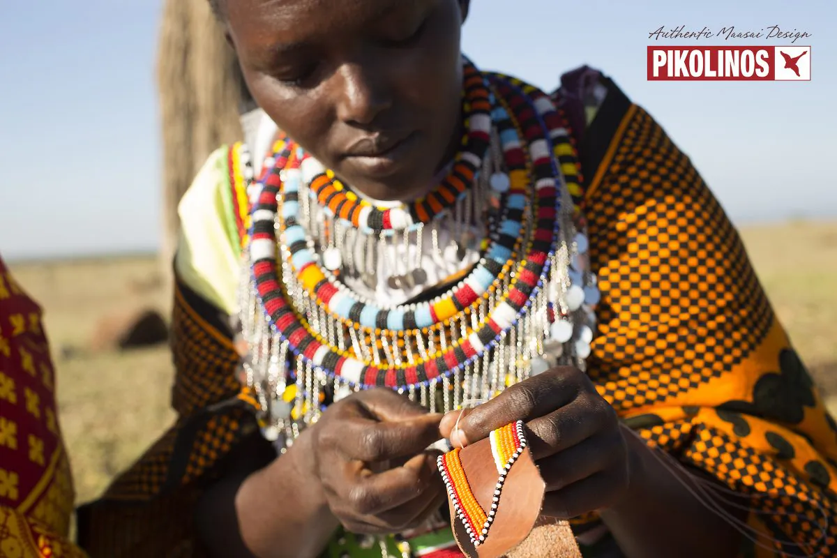 A publicity image from Pikolinos showing a Maasai woman embroidering a piece of leather with beads. (Courtesy of Pikolinos)