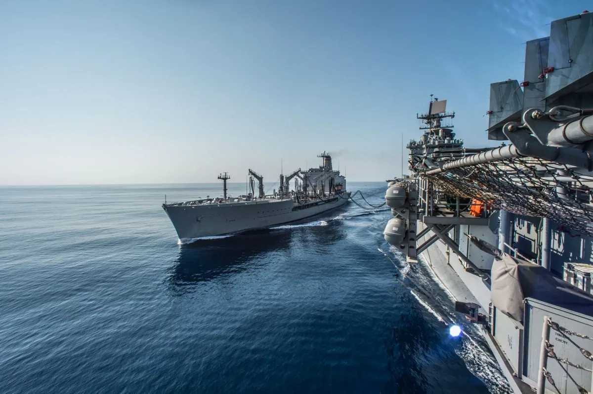 The amphibious assault ship USS Bonhomme Richard (LHD 6) conducts a replenishment-at-sea with the Military Sealift Command fleet replenishment oiler USNS Rappahannock (T-AO 204) in the Luzon Strait, Philippines, on March 1. The United States can now deploy troops to Philippine military bases near the disputed Spratly Islands. (U.S. Navy photo by Mass Communication Specialist 3rd Class Kevin V. Cunningham/Released)