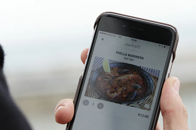 A UberEats user ordering food delivery from the existing Uber app. (Source Uber) 