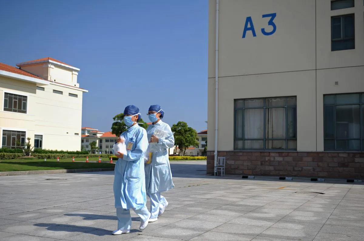 In this photo taken on May 14, 2013 two nurses walk at an isolation hospital in southwest Shanghai. (Peter Parks/AFP/Getty Images)