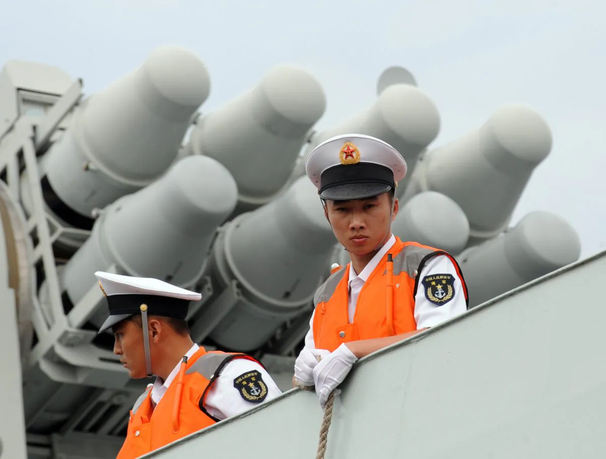 Sailors with the Chinese regime's People's Liberation Army Navy stand on the deck of a missile frigate in Manila on April 13, 2010. Experts are worried the Chinese regime will establish a new defensive zone in the South China Sea. (TED ALJIBE/AFP/Getty Images)
