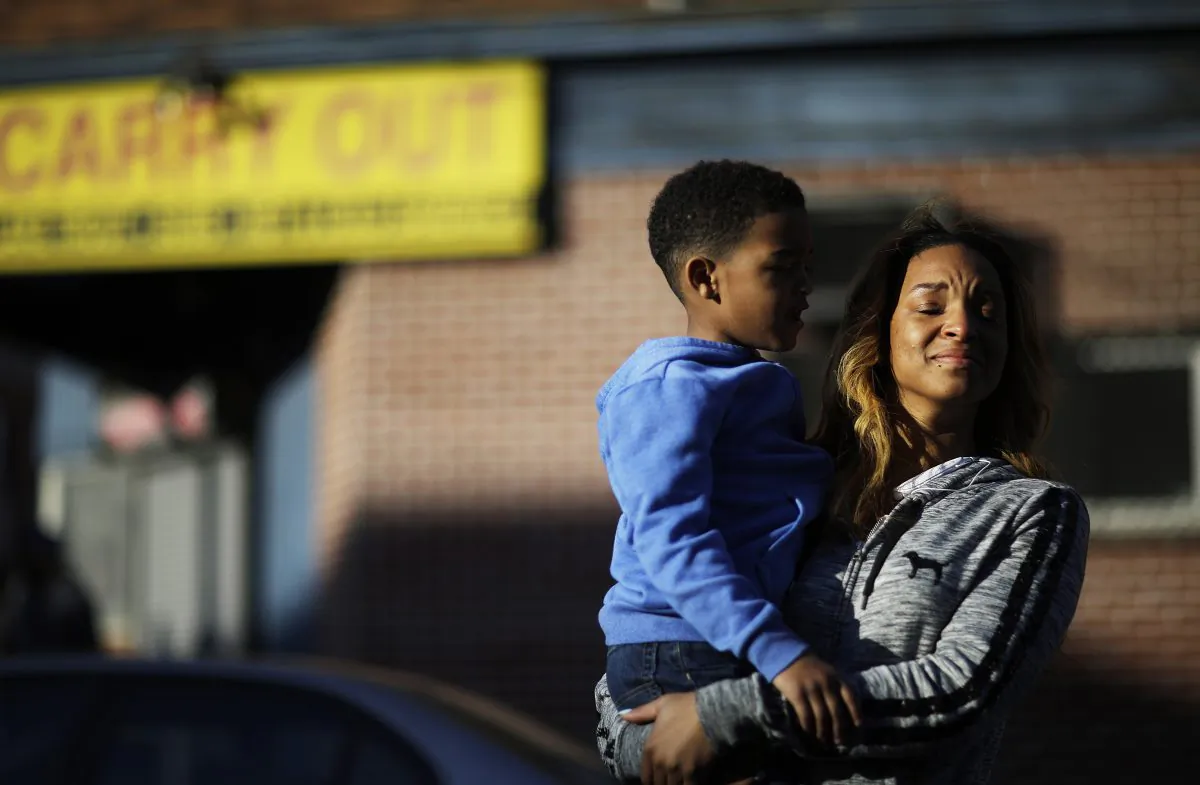 Cierra Powell and her son, Keon Lovitt, 6, at an outdoor church service a block from Monday's riots after the funeral for Freddie Gray, who died in police custody, in Baltimore on April 28, 2015. (AP Photo/David Goldman)