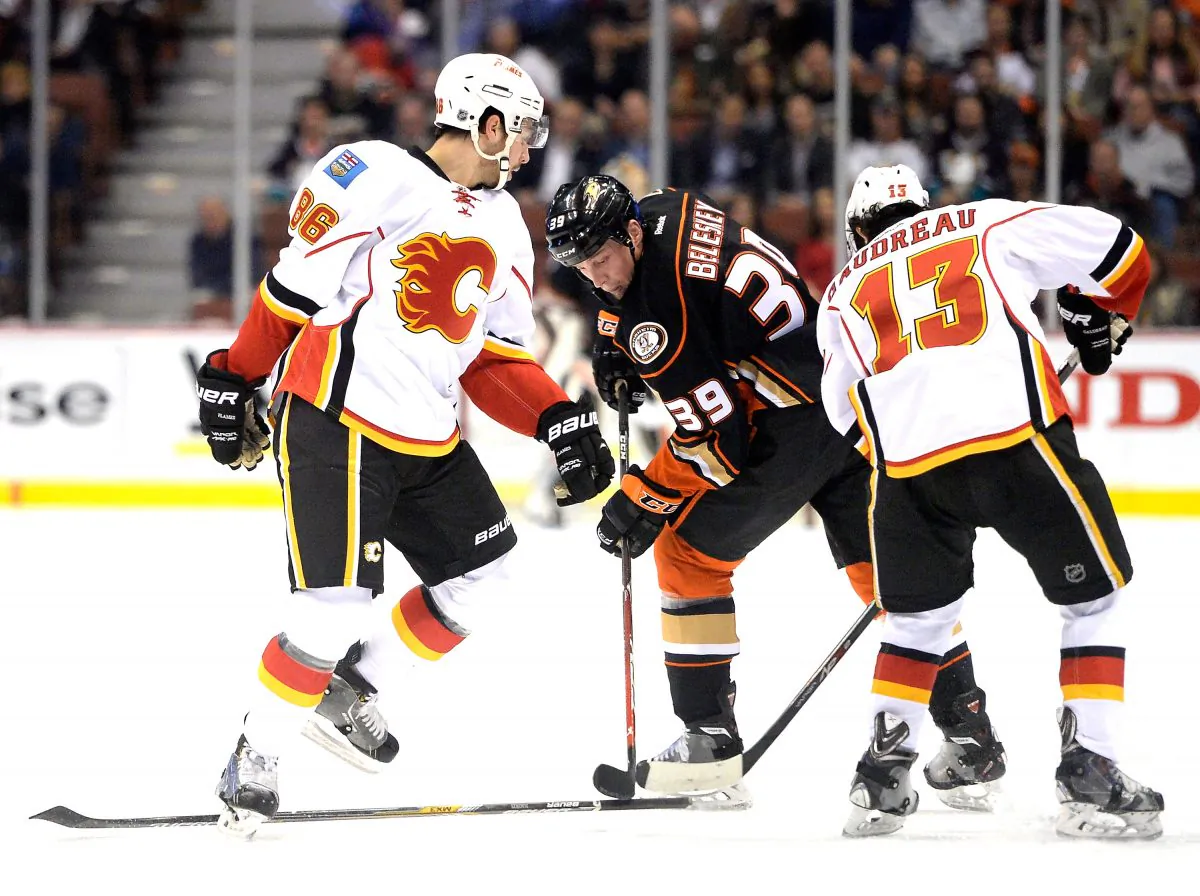 Matt Beleskey of the Anaheim Ducks takes a slashing penalty on Josh Jooris of the Calgary Flames as Johnny Gaudreau looks for the puck in regular season NHL action on Jan. 21, 2015 in Anaheim, California. (Harry How/Getty Images)