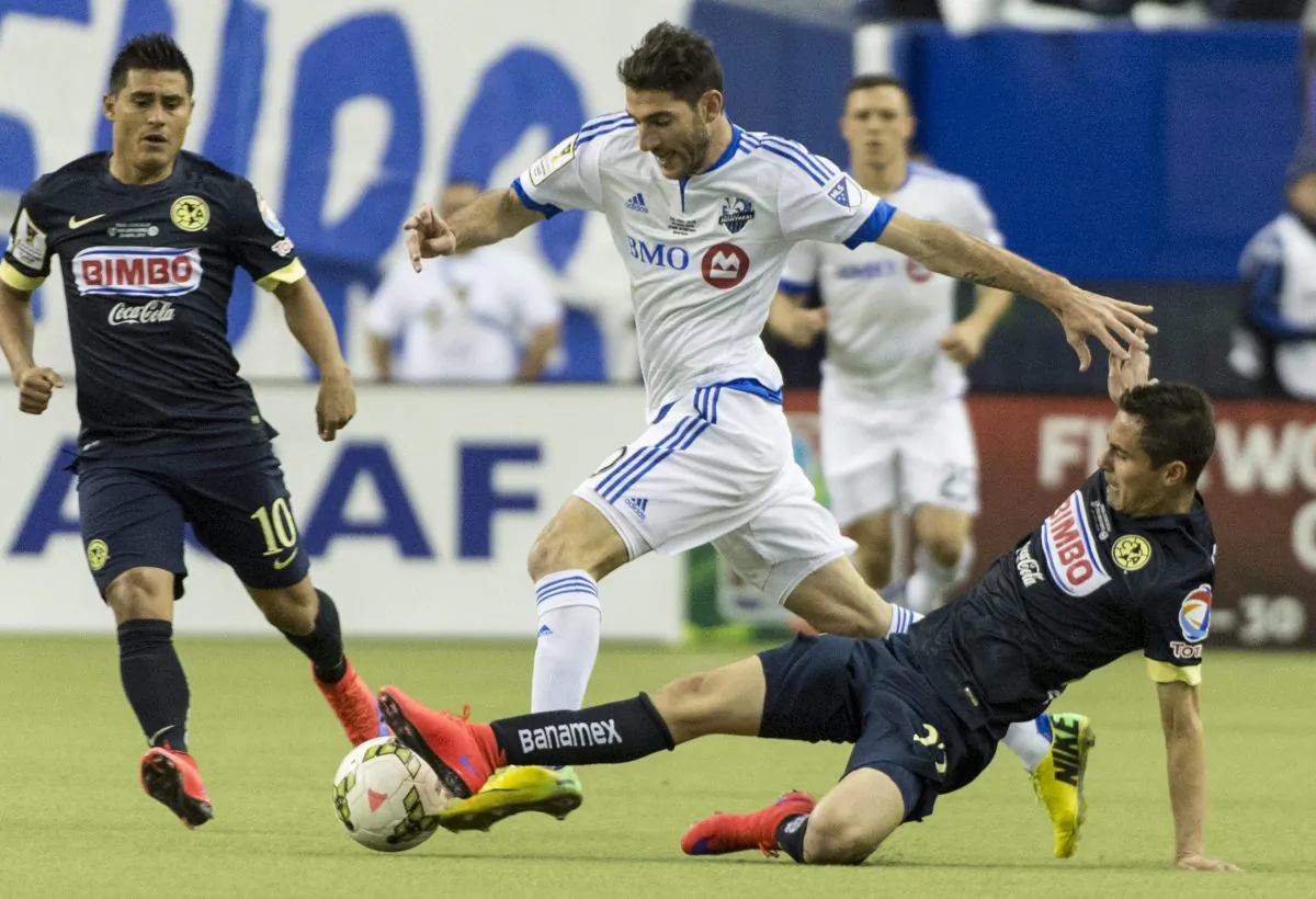 Montreal Impact midfielder Ignacio Piatti knocks the ball away from Club América defender Paul Aguilar at Stade Olympique in Montreal. Club América won CONCACAF Champions League with an outstanding performance on April 29, 2015. (The Canadian Press/Paul Chiasson)