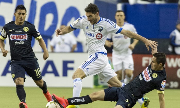Montreal Impact midfielder Ignacio Piatti knocks the ball away from Club América defender Paul Aguilar at Stade Olympique in Montreal. Club América won CONCACAF Champions League with an outstanding performance on April 29, 2015. (The Canadian Press/Paul Chiasson)