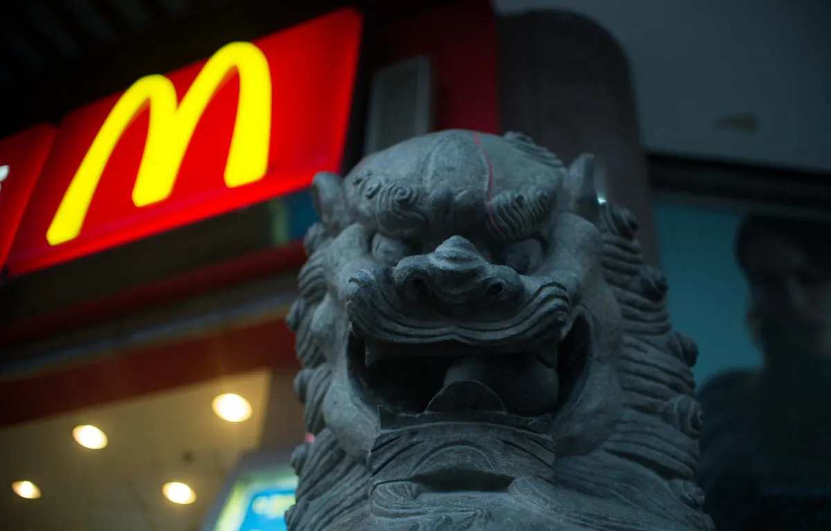 A lion statue is pictured next to a McDonald's fast food restaurant in Shanghai on July 28, 2014. (Johannes Eisele/AFP/Getty Images)