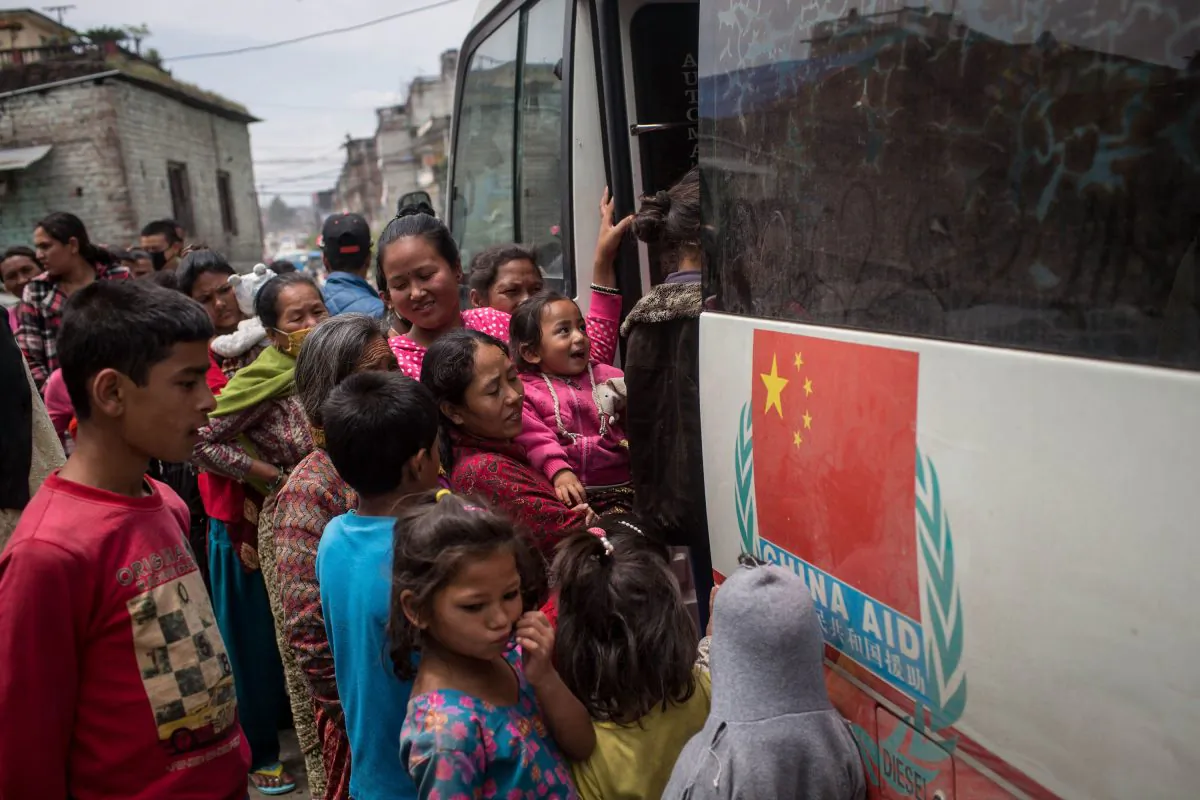 People wait in line to be seen by doctors at a mobile hospital bus on April 30, 2015 in Kathmandu, Nepal. (Chris McGrath/Getty Images)