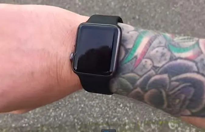 A screenshot of a video posted to YouTube by Michael Lovell showing how he has to frequently re-enter his password when wearing his Apple Watch on his tattooed arm. (Michael Lovell/YouTube)