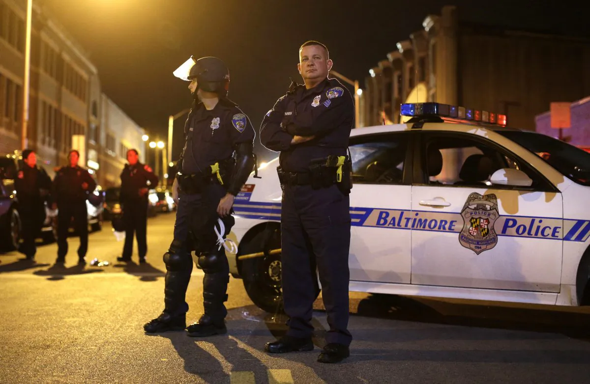 Members of the Baltimore Police Department wait for curfew to begin for the third night, Thursday, April 30, 2015, in Baltimore. (AP Photo/Patrick Semansky)