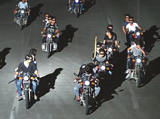 Knife-wielding bikers on the move in an undated photo. (Screen shot/Apple Daily) 