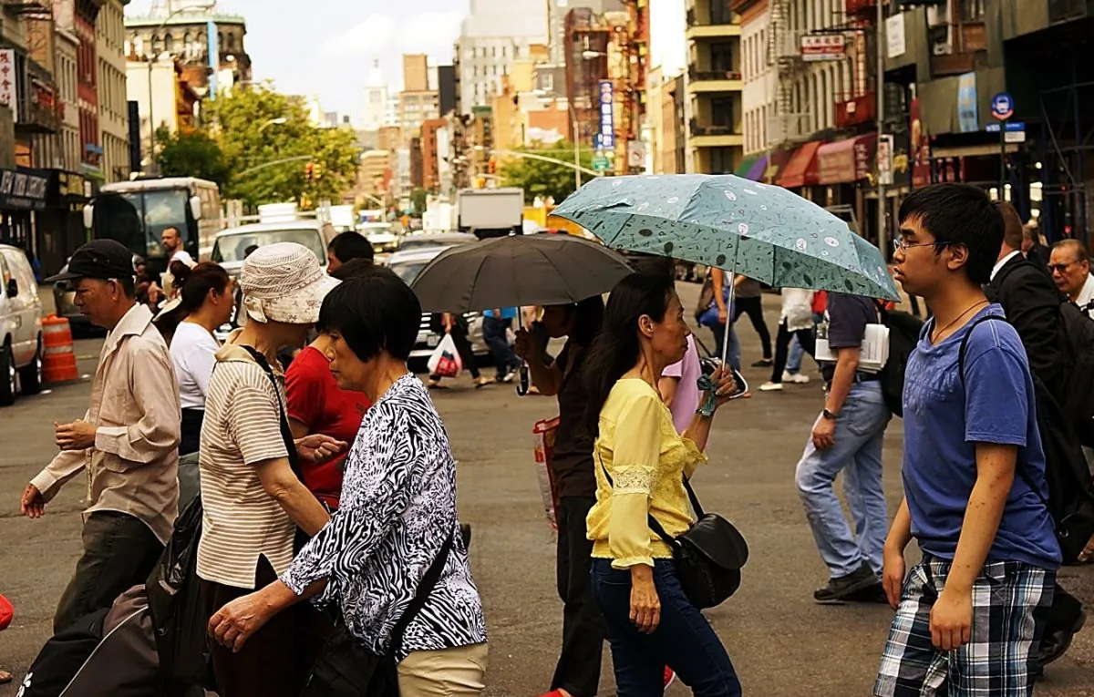 People walk through New York's Chinatown district on July 11, 2014 in New York City. (Spencer Platt/Getty Images)