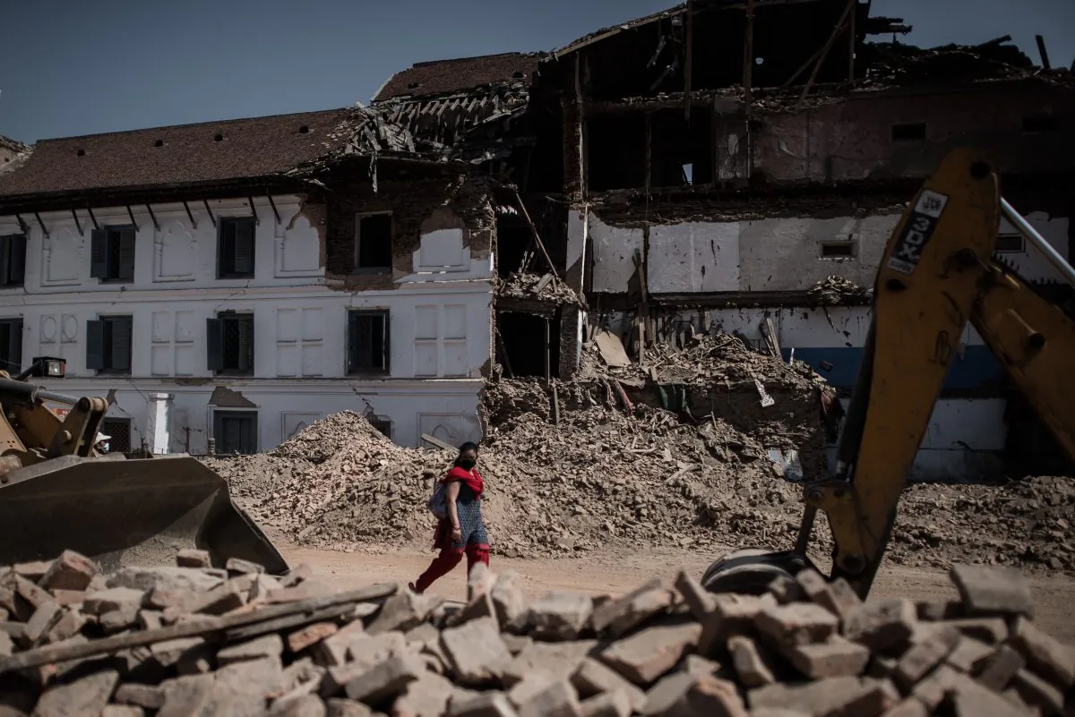 A woman walks past debris-strewn historical heritage site Durbar Square in Kathmandu on May 3, following a magnitude-7.8 earthquake, which struck the Himalayan nation on April 25. The death toll in Nepal from the devastating earthquake has risen to 7,040, an official from the National Emergency Operations Centre said on May 3. (Philippe Lopez/AFP/Getty Images) 