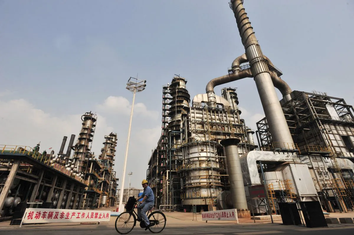 A worker rides a bicycle at an oil refinery of China's Sinopec, in Wuhan, central China's Hubei Province on May 10, 2011. (STR/AFP/Getty Images)