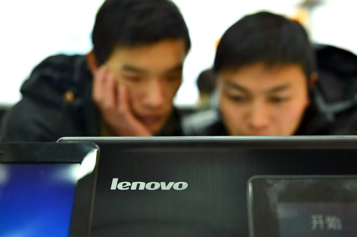 Chinese customers check out the computers at a Lenovo shop in Hangzhou, Zhejiang province on February 2, 2014. Lenovo computers have a new "High" severity security hole, say researchers. STR/AFP/Getty Images)