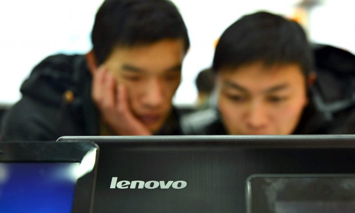 Chinese customers check out the computers at a Lenovo shop in Hangzhou, Zhejiang province on February 2, 2014. Lenovo computers have a new "High" severity security hole, say researchers. STR/AFP/Getty Images)
