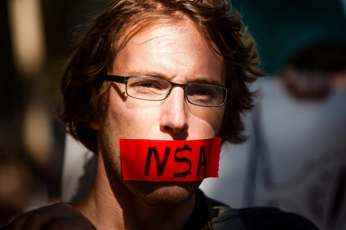 A protester with a piece of tape covering his mouth during the Stop Watching Us Rally protesting surveillance by the NSA, in Washington on Oct. 29, 2013. (Allison Shelley/Getty Images)