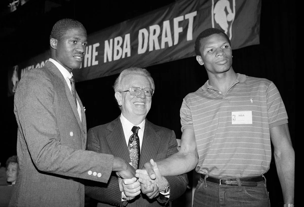 Dominique Wilkins, left, of the University of Georgia and Terry Cummings, right, of the DePaul University, join National Basketball Association Commissioner Larry O'Brien Tuesday, June 29, 1982 in New York after they were chosen in the NBA Draft. Wilkins, the third pick overall, went to the Utah Jazz and Cummings, the second pick in the first round of the draft, will go to the San Diego Clippers. (AP Photo/Marty Lederhandler)