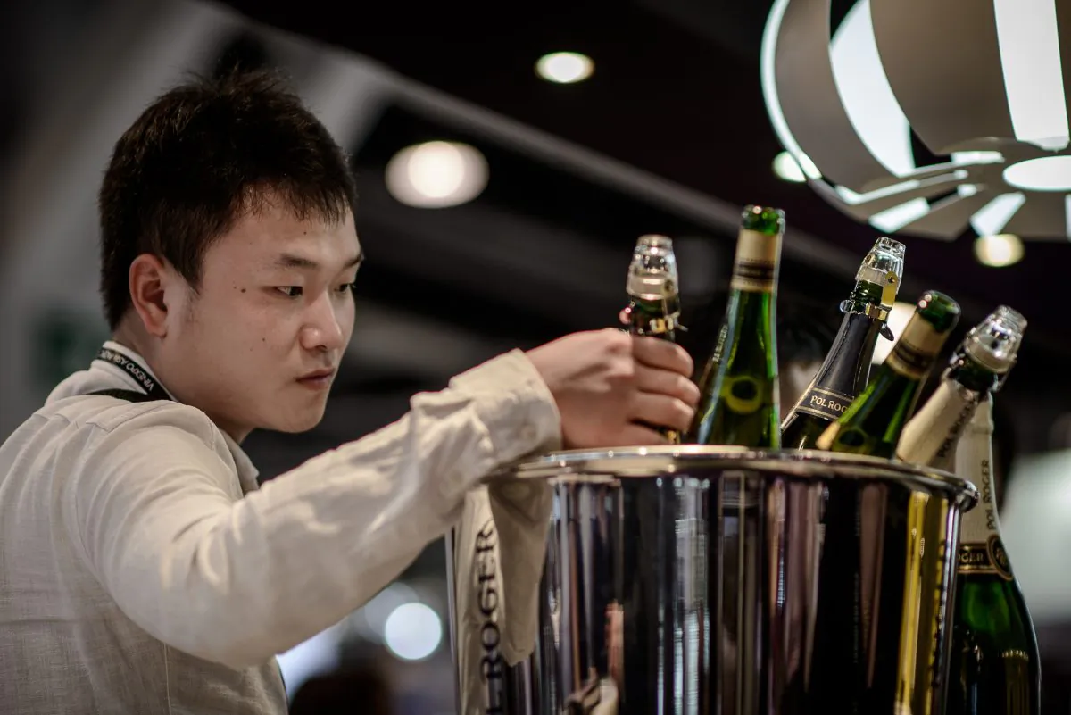 A visitor is checking bottles of Champagne at the Vinexpo Asia Pacific in Hong Kong, on May 27, 2014. On the international financial change, China is very close to pop the Champaign at the end of the year. (PHILIPPE LOPEZ/AFP/Getty Images) 