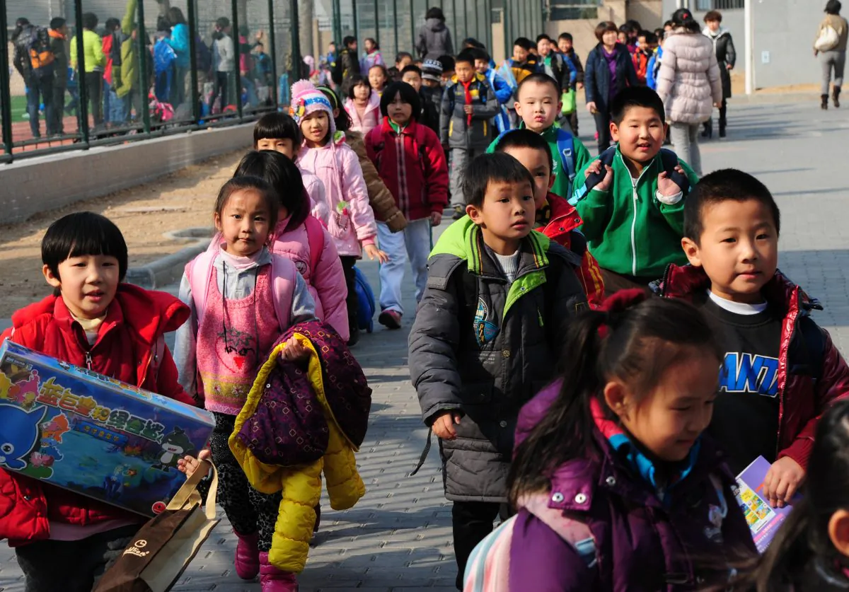 School children leave their elementary school at the end of classes in Beijing on March 13, 2012. (Mark Ralston/AFP/Getty Images)