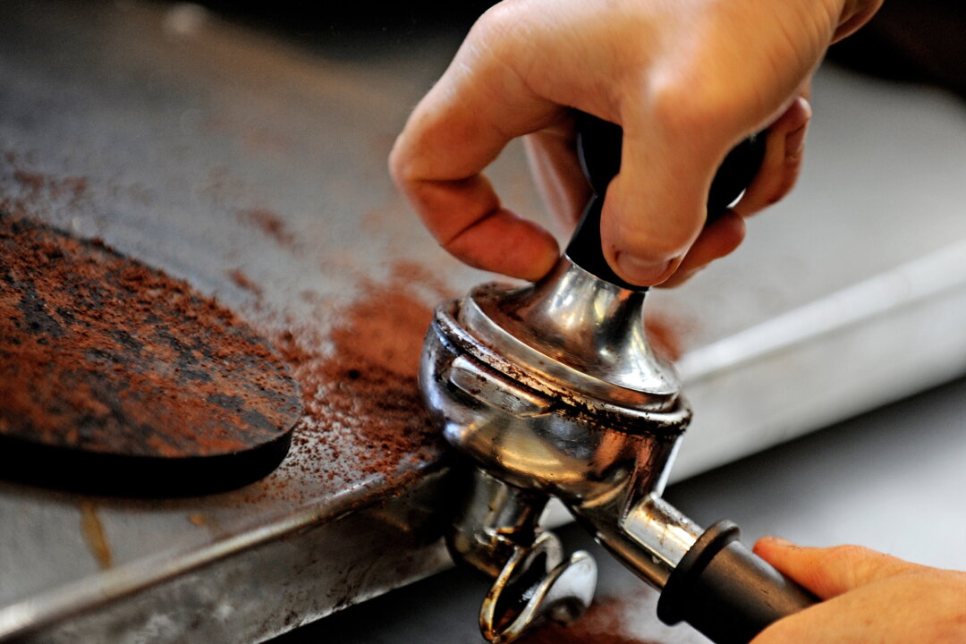 A tamper is used to prepare coffee grounds. (Greg Wood/AFP/Getty Images, file)