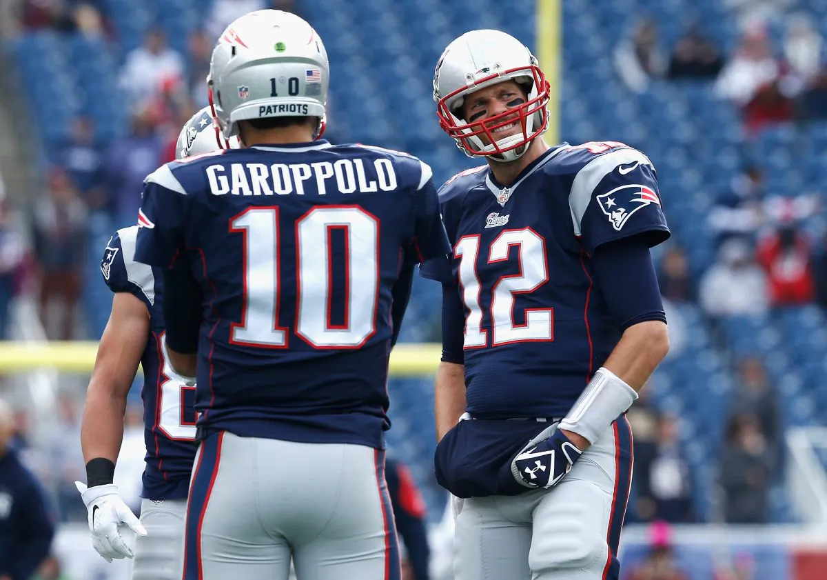 Jimmy Garoppolo (L) will likely see some playing time during Tom Brady's four-game suspension. (Photo by Jim Rogash/Getty Images)