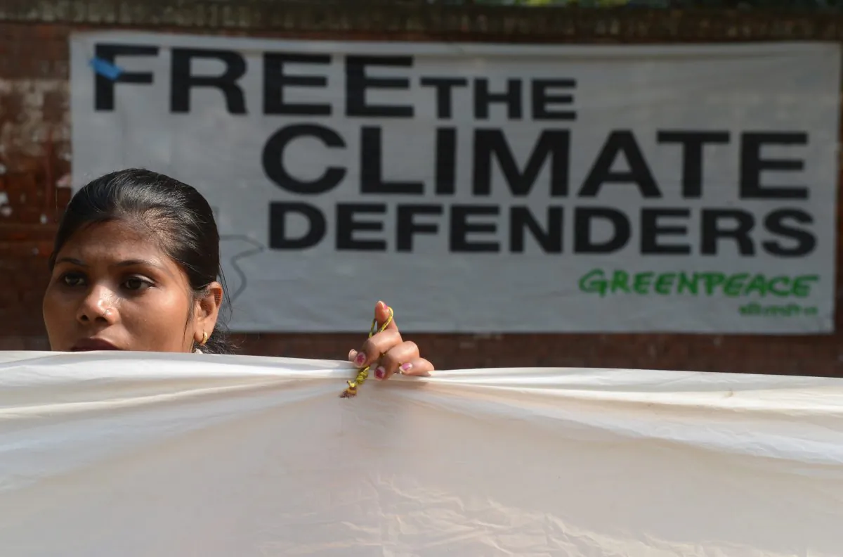 A Greenpeace activist demonstrates during a 30-hour long protest in New Delhi on November 16, 2013, to demand the release of a group of Greenpeace activists being held in Russia. (RAVEENDRAN/AFP/Getty Images)