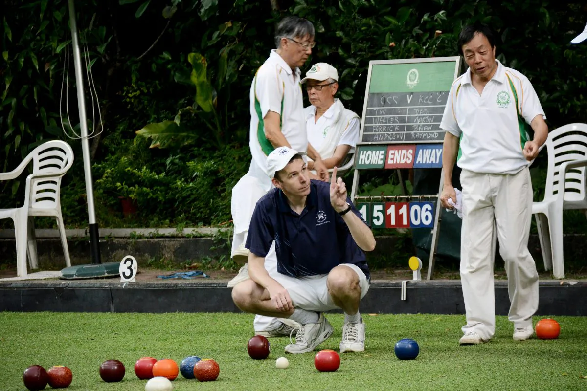 Derek Wyllie of Hong Kong Football Club indicates to his Craigengower Cricket Club opponent that his team has won a shot in this end. His rink continues the momentum and won the game 19:9, contributing to the overall victory of 5-3 away from home at CCC on Saturday May 9, 2015. (Stephanie Worth)