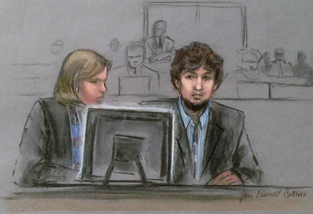 In this courtroom sketch, Dzhokhar Tsarnaev, right, and defense attorney Judy Clarke are depicted watching evidence displayed on a monitor during his federal death penalty trial Monday, March 9, 2015, in Boston. (Jane Flavell Collins via AP)