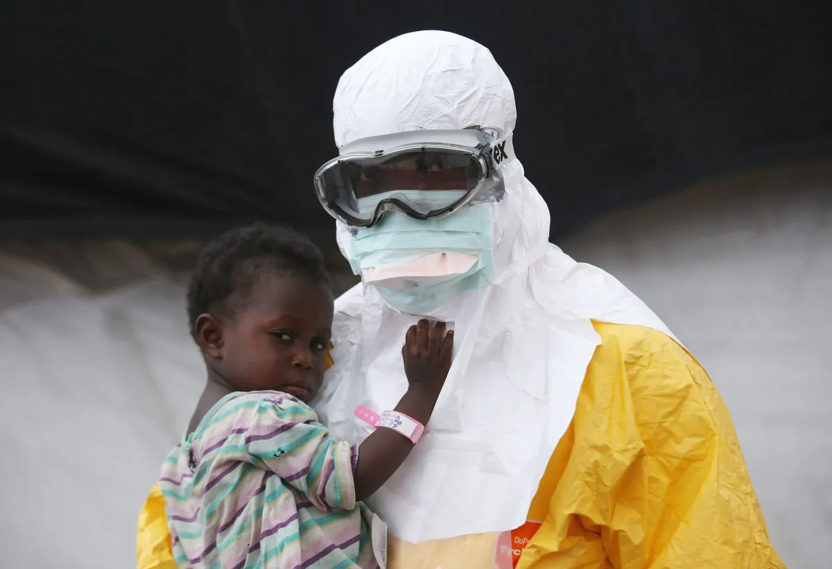 A Doctors Without Borders (MSF), health worker in protective clothing holds a child suspected of having Ebola in the MSF treatment center on October 5, 2014 in Paynesville, Liberia. (John Moore/Getty Images)
