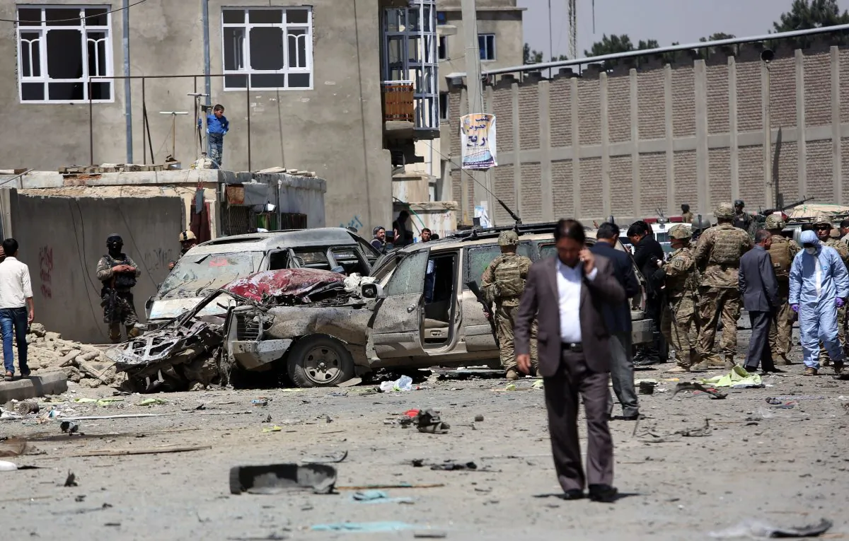 U.S. and Afghan security forces inspect the site of suicide attack near an international airport in Kabul, Afghanistan, Sunday, May 17, 2015.  (AP Photo/Rahmat Gul)