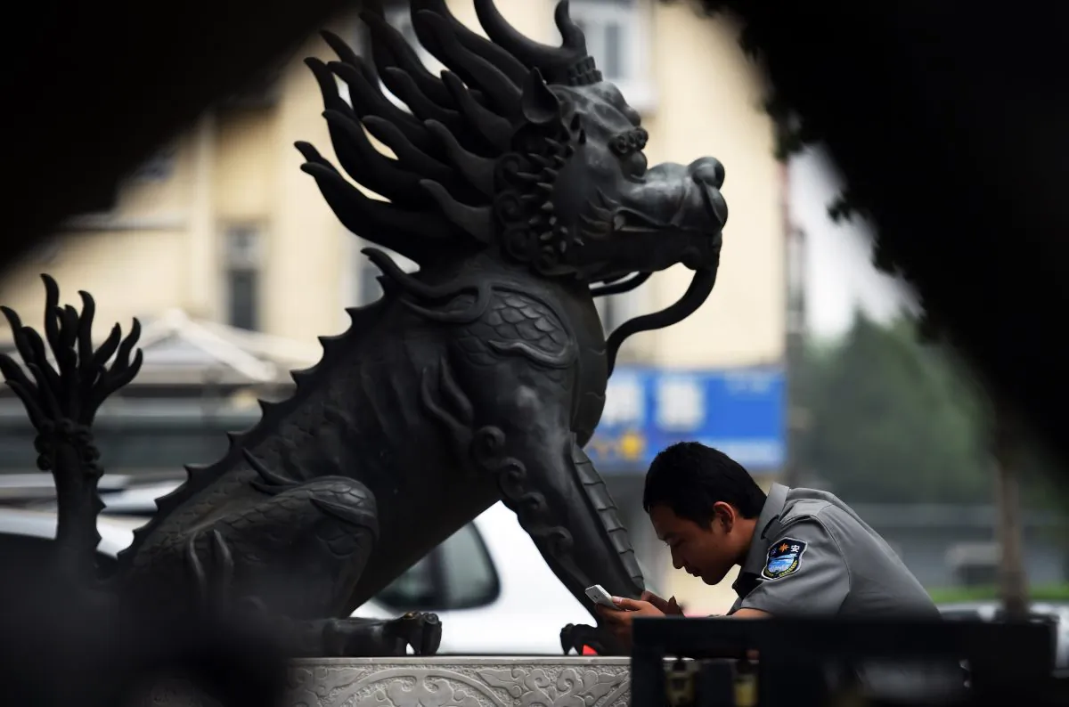 A security guard outside a bank in Beijing on July 3, 2014. China and the Western-led IMF are very close on reaching an agreement on increasing Chinese influence on the global financial system. (GREG BAKER/AFP/Getty Images)