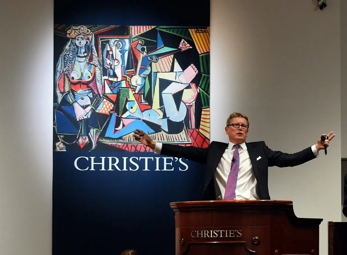 Auctioneer Jussi Pylkkanen takes bids on the Picasso painting 'Les Femmes d'Alger (Version O)' at Christie's in New York City on May 11, 2015, which went for USD 179.3 million, smashing the record for most expensive art sold at auction. (Timothy A. Clary/AFP/Getty Images)